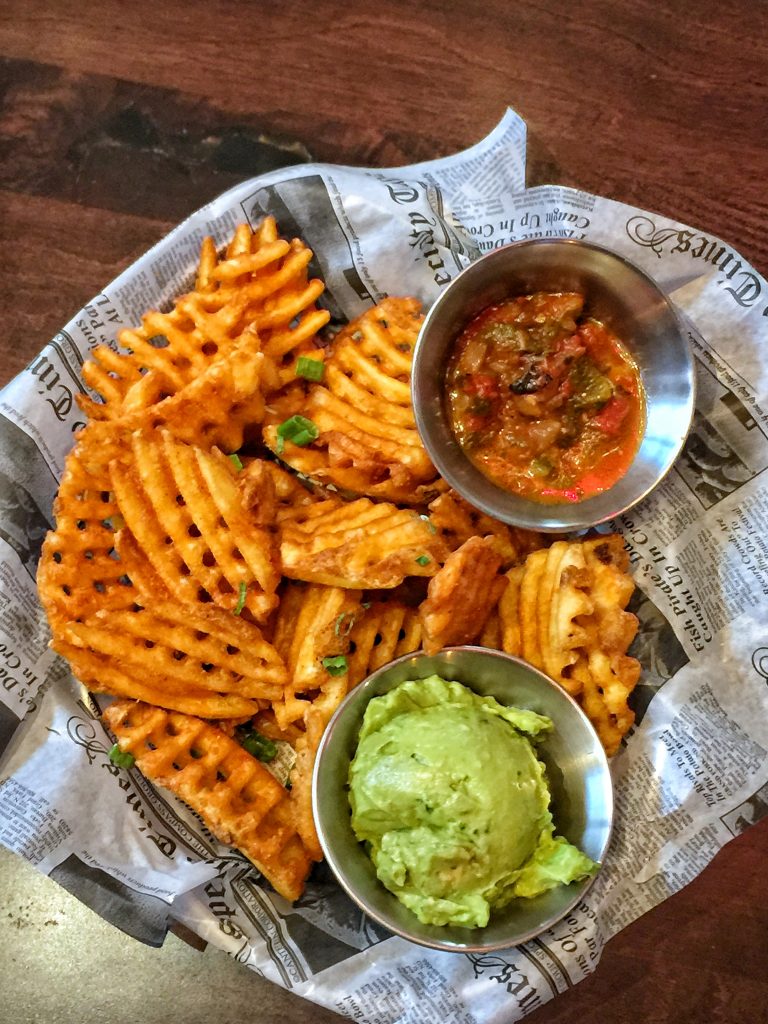 Crispy Waffle Fries loaded with Queso Blanco, Bacon, and Scallions